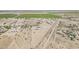 Desert landscape with a home on a fenced property surrounded by vast farmland at 8912 N Johnson Ct, Maricopa, AZ 85139