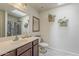 Bright bathroom with skylight, white vanity top, and shower with glass door at 8912 N Johnson Ct, Maricopa, AZ 85139