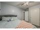 Cozy bedroom featuring soft blue walls, comfortable bedding, and convenient closet access at 8912 N Johnson Ct, Maricopa, AZ 85139
