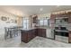 Modern kitchen featuring granite countertops, stainless steel appliances, and dark wood cabinetry at 8912 N Johnson Ct, Maricopa, AZ 85139