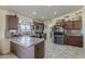 Well-appointed kitchen with a breakfast bar, stainless steel appliances, and ample cabinet space at 8912 N Johnson Ct, Maricopa, AZ 85139