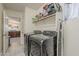 Functional laundry room with washer, dryer, shelving, and access to the kitchen at 8912 N Johnson Ct, Maricopa, AZ 85139