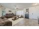 Inviting living room with tile flooring, neutral walls, and ample natural light from large windows at 8912 N Johnson Ct, Maricopa, AZ 85139