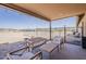 Covered patio with outdoor seating and views of the fenced backyard and desert landscape at 8912 N Johnson Ct, Maricopa, AZ 85139