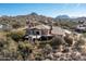 Desert estate aerial view showcasing the covered patio and natural desert landscaping at 10010 E Blue Sky Dr, Scottsdale, AZ 85262