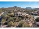 Aerial view of the property nestled among lush desert landscaping, showcasing mountain views and serene surroundings at 10010 E Blue Sky Dr, Scottsdale, AZ 85262