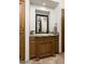 Bathroom featuring modern sink and faucet, wooden cabinet, and framed mirror at 10010 E Blue Sky Dr, Scottsdale, AZ 85262