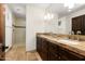 Bathroom featuring a granite countertop, double sinks, tile flooring and a glass shower, providing modern elegance at 10010 E Blue Sky Dr, Scottsdale, AZ 85262