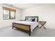 Bright bedroom featuring a bed with wooden frame, bedside tables, and view to the outside at 10010 E Blue Sky Dr, Scottsdale, AZ 85262