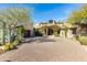 Charming desert home with paver driveway, lush landscaping and an attached garage at 10010 E Blue Sky Dr, Scottsdale, AZ 85262