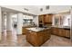 The well-appointed kitchen offers an expansive island with a stainless steel cooktop and custom wood cabinets at 10010 E Blue Sky Dr, Scottsdale, AZ 85262
