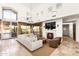 Bright living room featuring a fireplace, large windows, tile flooring, and comfortable seating at 10010 E Blue Sky Dr, Scottsdale, AZ 85262