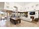 Open living space with dining area, high ceilings, fireplace, and access to the outdoor patio at 10010 E Blue Sky Dr, Scottsdale, AZ 85262