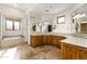 The main bathroom includes double sinks, stone counters, a tub, and ample lighting to brighten your day at 10010 E Blue Sky Dr, Scottsdale, AZ 85262