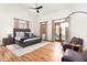 The main bedroom features hardwood floors, a ceiling fan, a sitting area, and access to the outdoors at 10010 E Blue Sky Dr, Scottsdale, AZ 85262