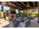 Inviting outdoor patio area with a fireplace, desert views, and comfortable seating at 10010 E Blue Sky Dr, Scottsdale, AZ 85262