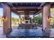 Beautiful outdoor patio featuring a fireplace, comfortable seating, and desert landscaping at 10010 E Blue Sky Dr, Scottsdale, AZ 85262