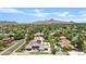 An aerial view displays the home with solar panels and inviting pool in a quiet suburban neighborhood at 101 E Linger Ln, Phoenix, AZ 85020