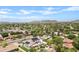 The aerial view showcases the community and the well-maintained homes, complete with mountain views at 101 E Linger Ln, Phoenix, AZ 85020