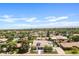 An aerial view shows the home and its neighborhood, complete with mature trees and city views at 101 E Linger Ln, Phoenix, AZ 85020