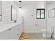 Bathroom featuring white subway tile, a double vanity, and white toilet at 101 E Linger Ln, Phoenix, AZ 85020