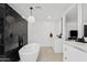 Bathroom featuring a modern soaking tub, marble tiled wall, and white cabinets at 101 E Linger Ln, Phoenix, AZ 85020