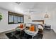 Bright bedroom featuring a ceiling fan, dark wood windowsills, and seating area at 101 E Linger Ln, Phoenix, AZ 85020