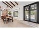 Dining room with exposed ceiling beams, elegant lighting, and views of the front yard at 101 E Linger Ln, Phoenix, AZ 85020