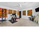 Spacious exercise room with multiple training apparatus and colorful artwork against a light color scheme at 101 E Linger Ln, Phoenix, AZ 85020