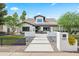 Stunning white home featuring a modern design, desert landscaping, and a welcoming walkway at 101 E Linger Ln, Phoenix, AZ 85020