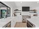 Bright modern kitchen with stainless steel appliances, a large window, and sleek white cabinetry at 101 E Linger Ln, Phoenix, AZ 85020