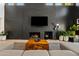 Elegant living room featuring a striking black fireplace, wood floors, and stylish decor at 101 E Linger Ln, Phoenix, AZ 85020