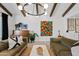 Bright living room with wood beam ceiling, modern light fixture, and comfortable seating arrangements at 101 E Linger Ln, Phoenix, AZ 85020