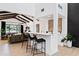 Spacious living room with wet bar, light wood flooring, and a view to the outdoor living space at 101 E Linger Ln, Phoenix, AZ 85020