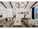 Airy living room with wood beam ceiling, modern light fixture, and comfortable seating arrangements at 101 E Linger Ln, Phoenix, AZ 85020