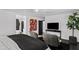 Main bedroom featuring a ceiling fan, seating area, TV, and ensuite bathroom at 101 E Linger Ln, Phoenix, AZ 85020