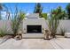 An inviting outdoor fireplace is beautifully accented with decorative lanterns and desert landscaping at 101 E Linger Ln, Phoenix, AZ 85020