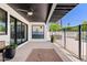 Covered patio with sleek design, desert-themed artwork, and a view of the swimming pool at 101 E Linger Ln, Phoenix, AZ 85020