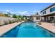 The private backyard pool is surrounded by lush greenery and ample patio space at 101 E Linger Ln, Phoenix, AZ 85020