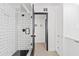 Modern shower featuring white subway tile and black hardware at 101 E Linger Ln, Phoenix, AZ 85020