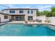 Backyard featuring a large swimming pool, patio area with outdoor furniture, and well-maintained landscaping at 101 E Linger Ln, Phoenix, AZ 85020