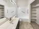 Clean bathroom showcasing a spacious vanity, walk-in shower, and ample lighting at 10242 N 66Th Ave, Glendale, AZ 85302