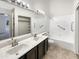 Bright bathroom featuring dual sinks, a vanity, and a shower-tub combination at 10242 N 66Th Ave, Glendale, AZ 85302