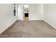 Comfortable bedroom with carpet flooring, a window, and a view towards the en-suite bathroom at 10242 N 66Th Ave, Glendale, AZ 85302