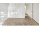 Clean bedroom with carpet flooring and white walls, showcasing a door leading to the hallway at 10242 N 66Th Ave, Glendale, AZ 85302