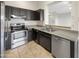 Well-equipped kitchen featuring stainless steel appliances, dark cabinets, and granite countertops at 10242 N 66Th Ave, Glendale, AZ 85302