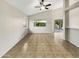 Spacious living room with vaulted ceilings and tile flooring with outdoor views from the windows at 10242 N 66Th Ave, Glendale, AZ 85302