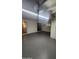 Spacious garage featuring a painted floor, overhead lighting, and access to the home at 10582 W Oakmont Dr, Sun City, AZ 85351