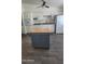 Bright kitchen with white cabinets, a convenient portable island, and modern appliances at 10582 W Oakmont Dr, Sun City, AZ 85351