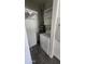 Functional laundry area featuring a washer, water heater, and overhead shelving at 10582 W Oakmont Dr, Sun City, AZ 85351
